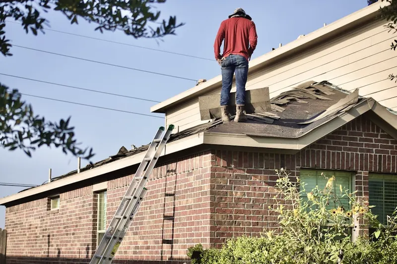 Professional roofer working on a residential roof in Landstreet